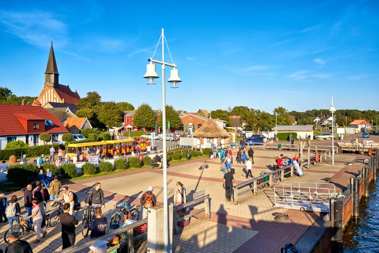 Tourists in the harbor of Schaprode. From here drive the ferryboats to the island Hiddensee. A very popular destination.